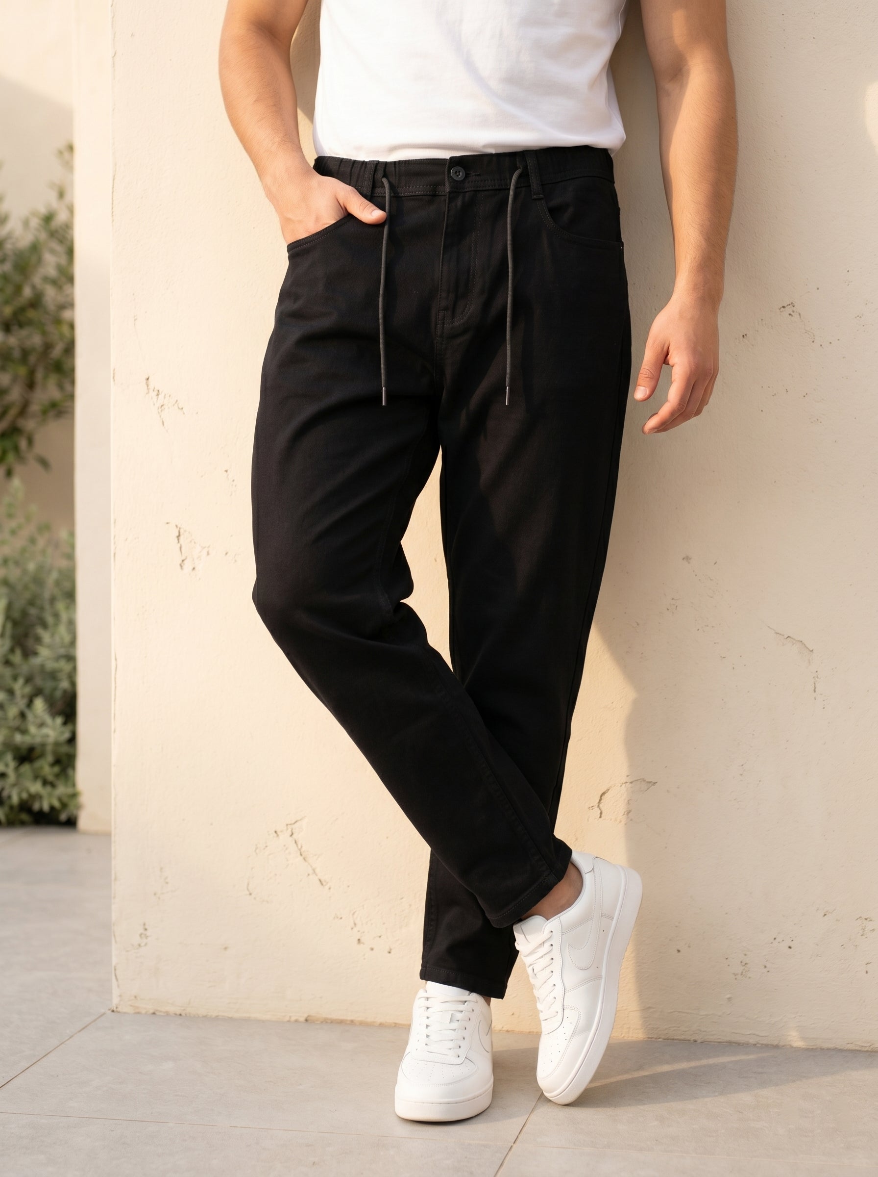 Snipes carrot fit denim jeans, slim fit style with classic blue denim fabric, shown on a model.