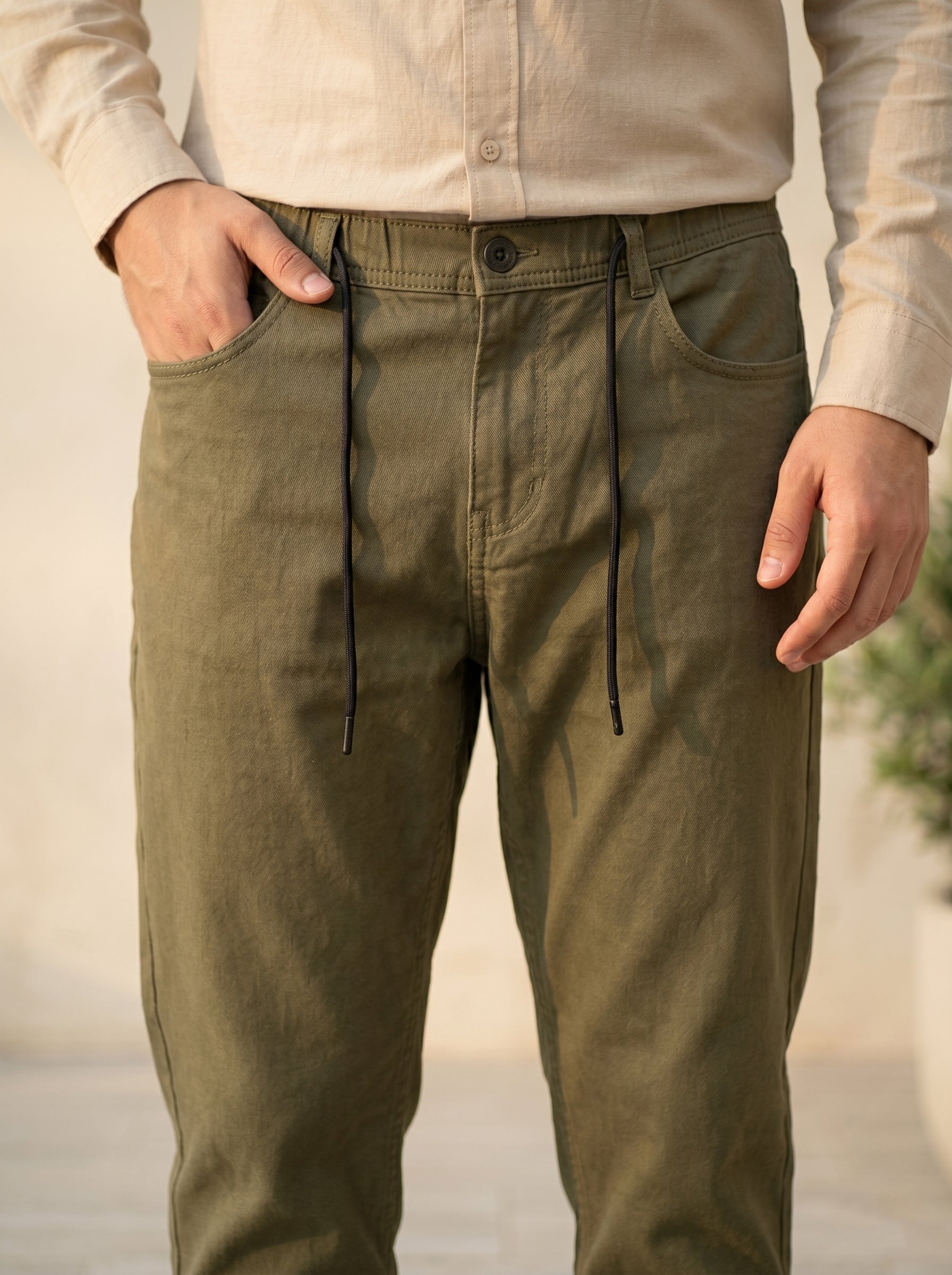 Snipes carrot fit denim jeans shown on a model, featuring a slim, tapered silhouette and classic blue denim fabric.