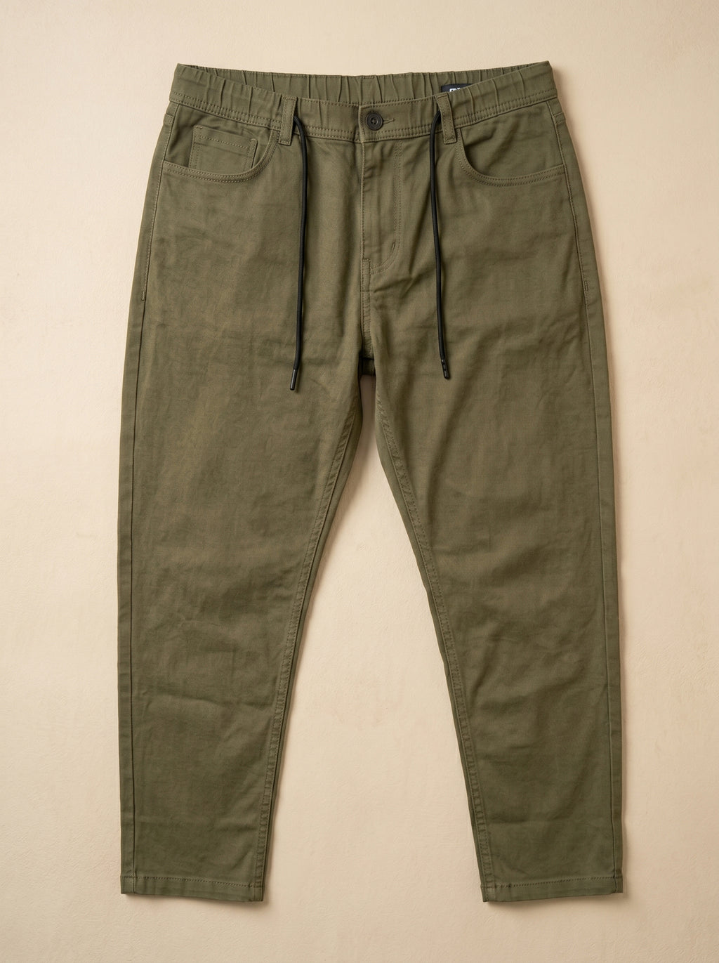 Snipes carrot fit denim jeans showing slim, tapered design in classic blue denim fabric.