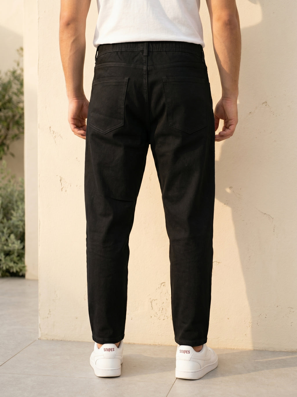 Snipes carrot fit denim jeans displayed on a model, showcasing the stylish fit and classic denim texture.