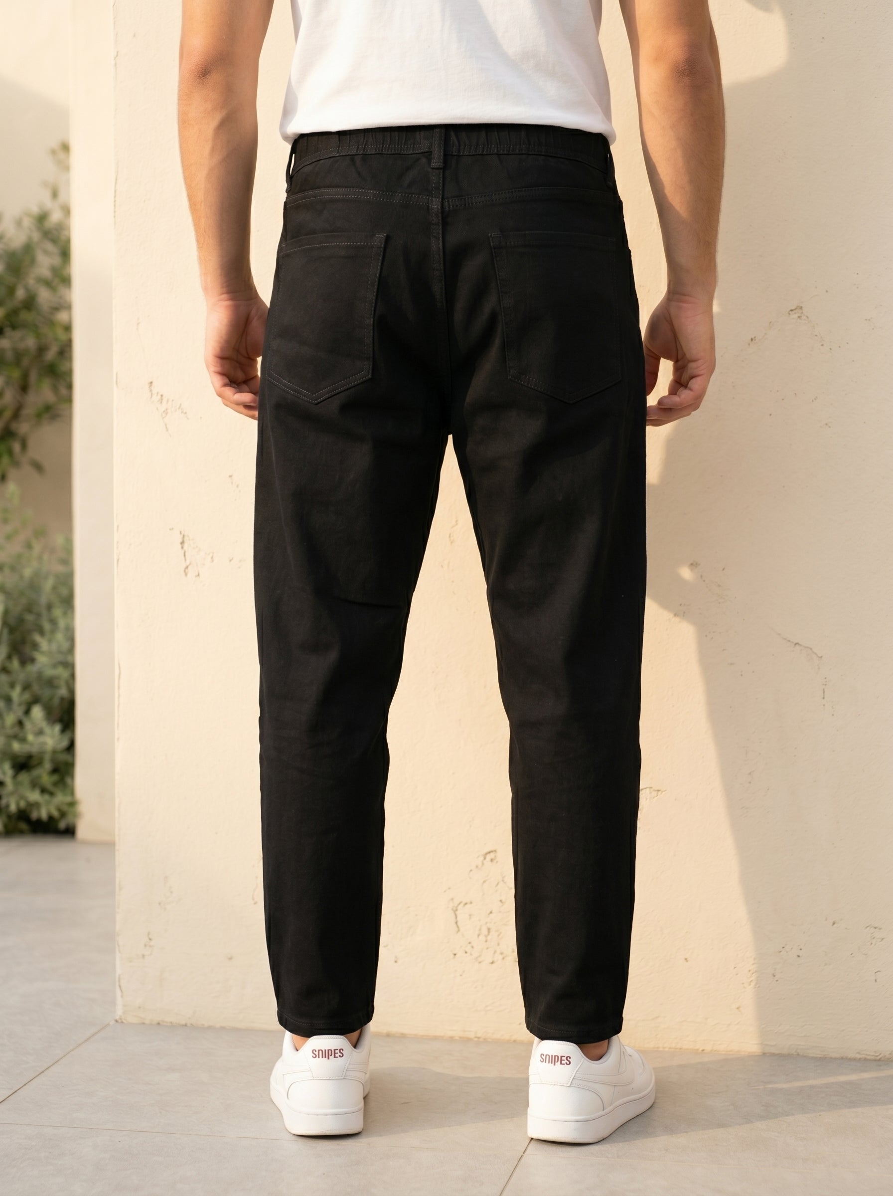 Snipes carrot fit denim jeans displayed on a model, showcasing the stylish fit and classic denim texture.