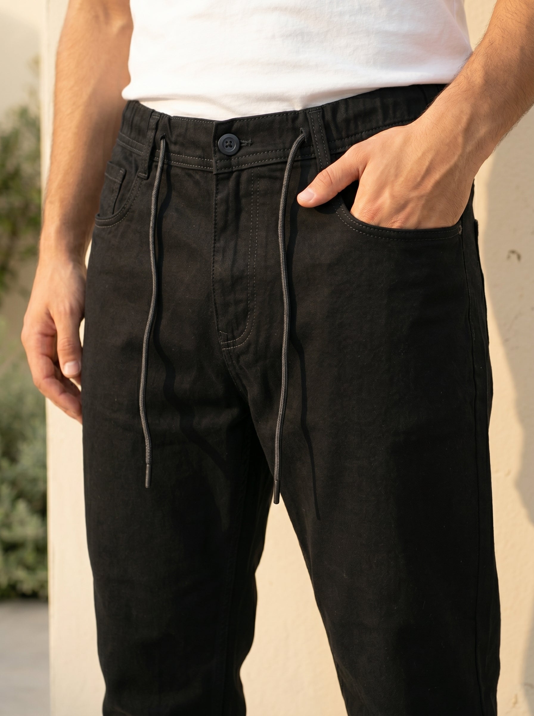 Snipes carrot fit denim jeans displayed on a model, showcasing slim fit cut and classic denim wash.