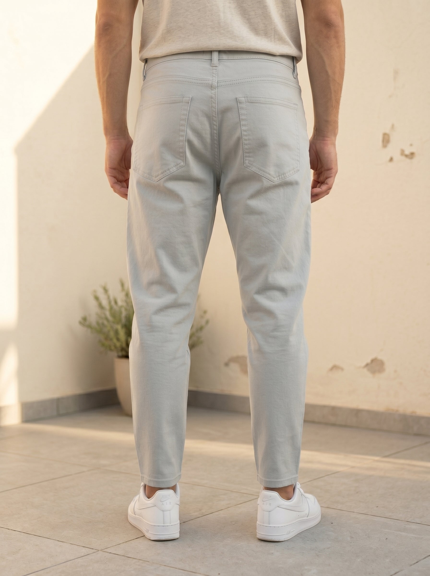 Snipes carrot fit denim jeans displayed on a hanger, showcasing the casual, tapered design and classic blue denim fabric.