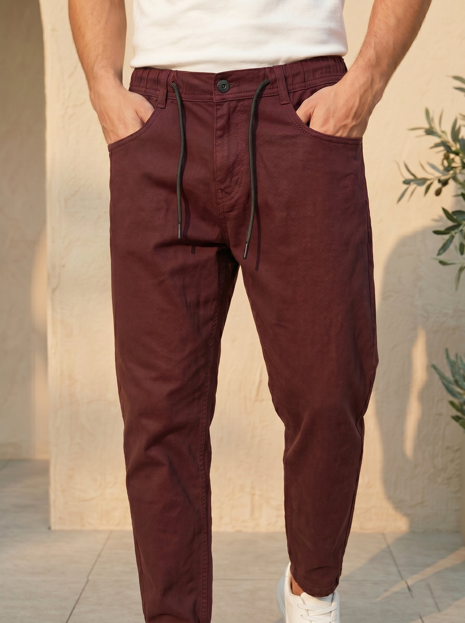 Snipes carrot fit denim jeans with classic blue wash and visible stitching, displayed on a hanger.