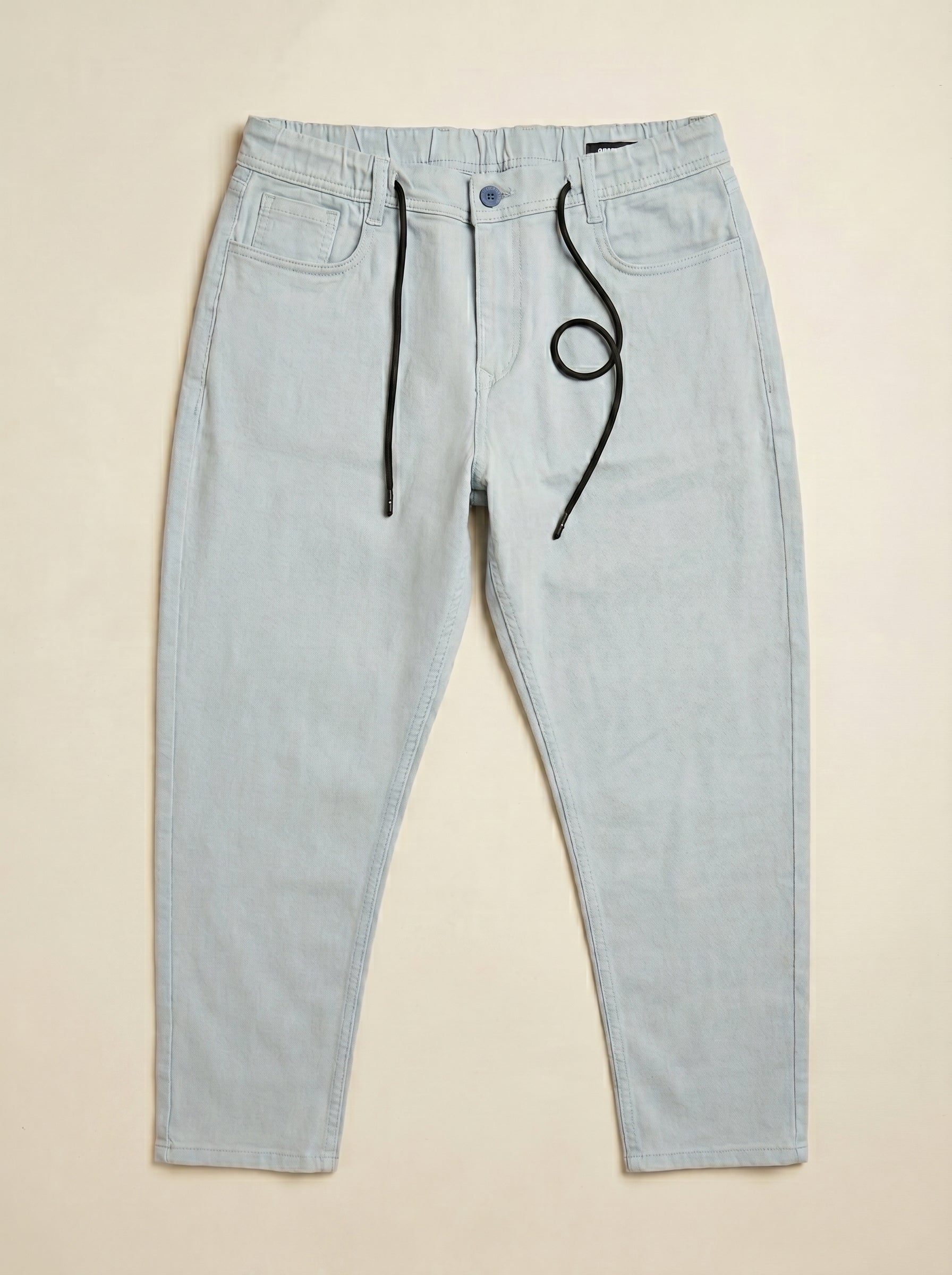Snipes carrot fit denim jeans showing front view, with classic five-pocket design and medium blue wash.
